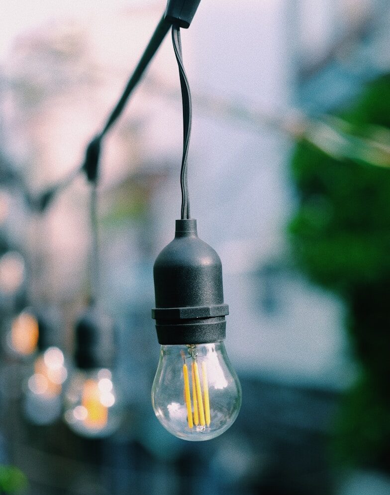 selective focus photography of clear string light